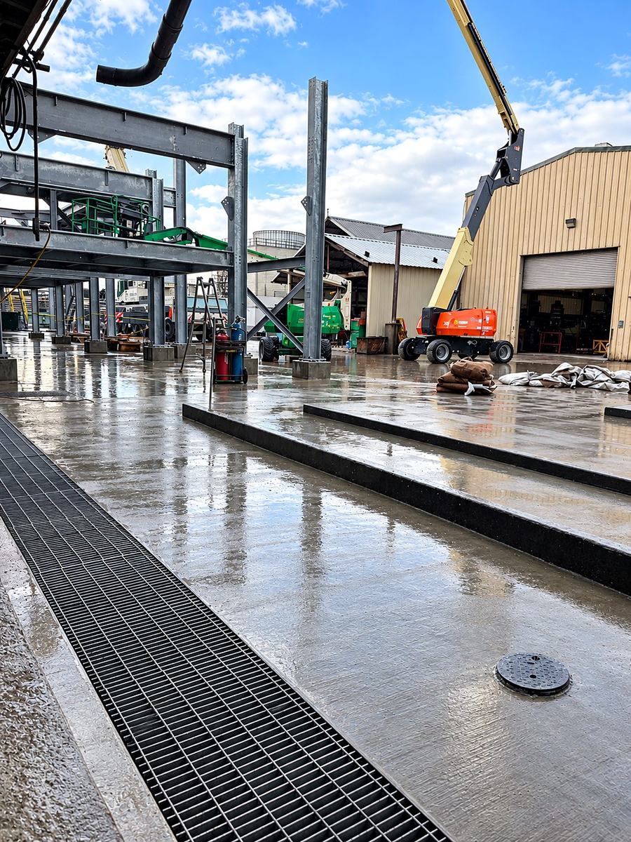 Finished concrete slab with an integrated trench drain and steel grate